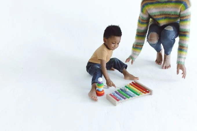 Criança brincando com um xilofone colorido