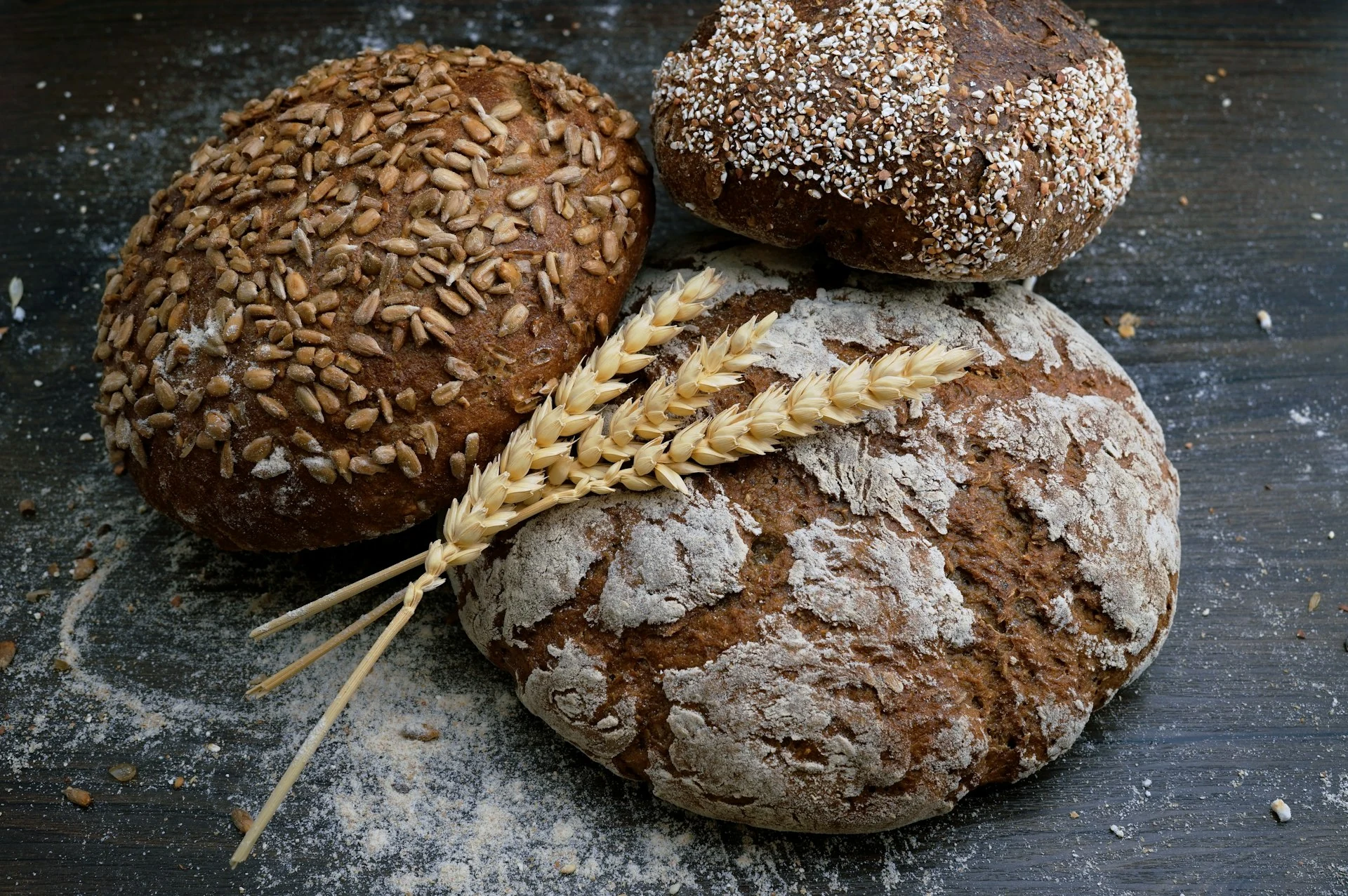 Pães artesanais recém-assados sobre balcão de madeira